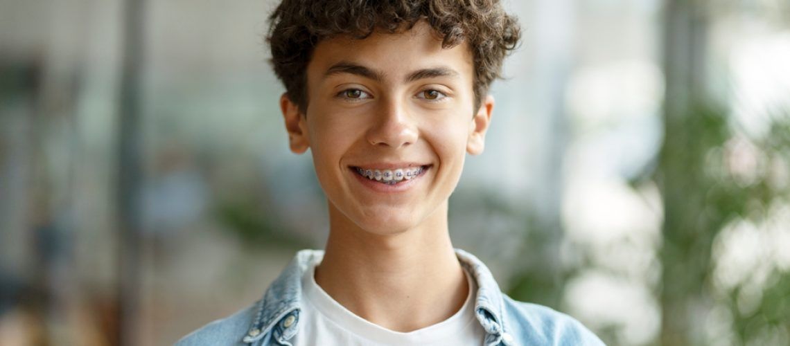Closeup,Portrait,Of,Smiling,Smart,Curly,Haired,School,Boy,Wearing