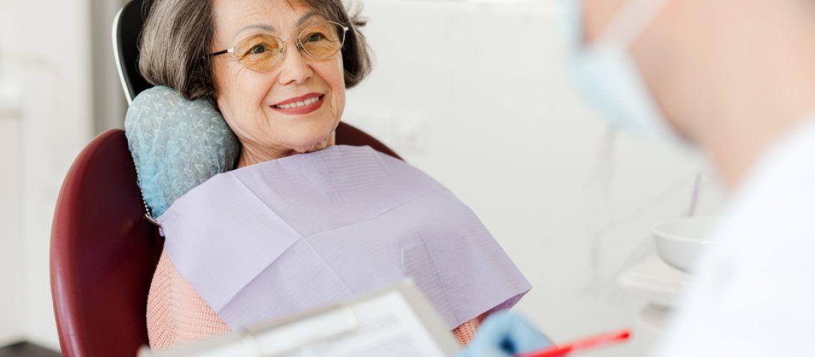 Smiling,,Beautiful,Senior,Woman,Sitting,In,Dental,Chair,On,Visit